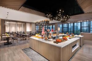 a buffet line with food on it in a restaurant at Courtyard by Marriott Nanjing Jiangning in Nanjing