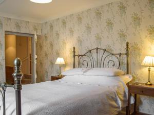 Henllan AmgoedにあるParke Cottageの花柄の壁紙を用いたベッドルーム1室