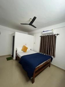a bedroom with a bed with a ceiling fan at HAKUNA MATATA - Best budget stay at Arambol Beach, Goa in Arambol