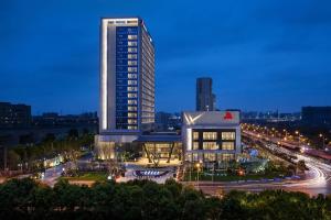 a tall building in a city at night at Shanghai Marriott Hotel Kangqiao in Shanghai