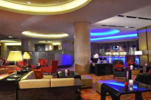 a lobby of a hotel with couches and a bar at Shanghai Marriott Hotel Riverside in Shanghai