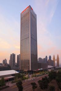 a tall building with a lot of windows in a city at Chongqing Marriott Hotel in Chongqing