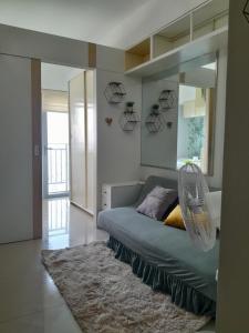 a bedroom with a bed with a mirror and a rug at Grass residences in Manila