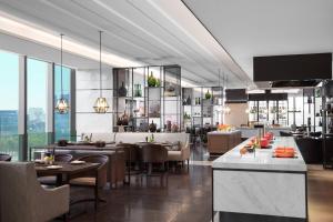 a restaurant with tables and chairs in a building at Marriott Nanjing South Hotel in Jiangning