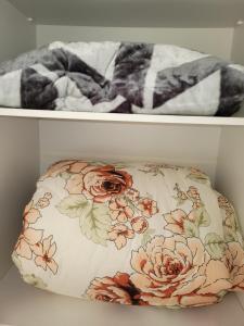 a pillow in a drawer with flowers on it at Vista para o Guaíba in Porto Alegre