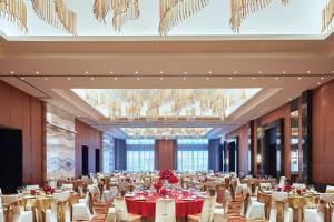 a banquet hall with tables and chairs and a chandelier at Zhuhai Marriott Hotel in Zhuhai +60 photos