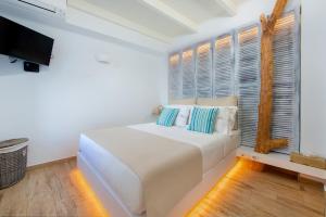 A bed or beds in a room at Lindos Allure Villa with Jacuzzi and Acropolis view!!!