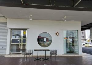 a table and two chairs in front of a building at TT99 COZY STAY in Miri
