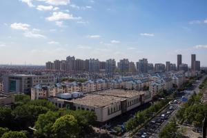 an aerial view of a city with tall buildings at Courtyard by Marriott Shanghai Fengxian in Fengxian