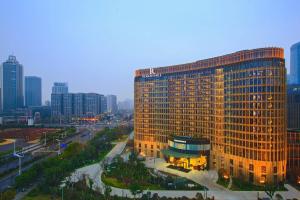 a large building in the middle of a city at Renaissance Nanjing Olympic Centre Hotel in Nanjing