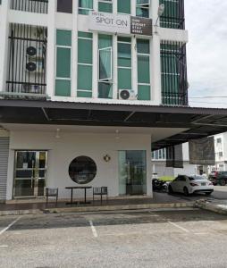 a building with a sign that reads stop on at TT99 COZY STAY in Miri