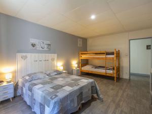 a bedroom with a bed and a bunk bed at Maison Cauterets, 5 pièces, 10 personnes - FR-1-401-271 in Cauterets