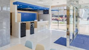 a lobby of a office with a blue ceiling at Toyoko Inn Osaka Dome Mae in Osaka