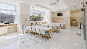 a large room with a table and chairs and a kitchen at Toyoko Inn Osaka Dome Mae in Osaka +40 photos