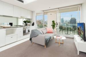 a living room with a couch and a table at DH707 - 1 bedroom unit Victoria St - Darlinghurst in Sydney