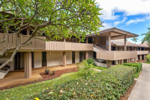 an apartment building with a garden in front of it at Eldorado A203 in Kahana