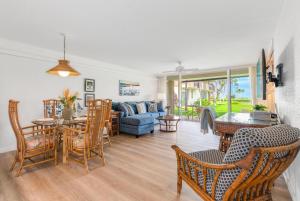 a living room with a couch and a table and chairs at Eldorado H107 in Kahana