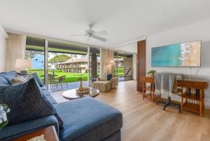 a living room with a blue couch and a table at Eldorado H107 in Kahana