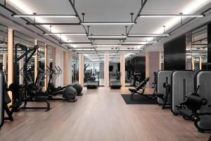 a gym with many treadmills and machines in it at Courtyard by Marriott Shanghai Minhang in Shanghai