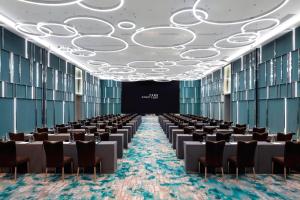 a large room with rows of tables and chairs at Courtyard by Marriott Shanghai Minhang in Shanghai