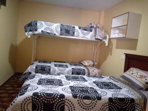 a bedroom with a bunk bed at Hostal Locuras en el Cielo in Baños