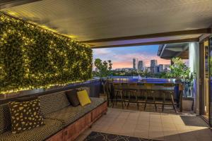 a balcony with a bar with a view of the city at Lush Tropical Paradise Home - Darwin City in Stuart Park