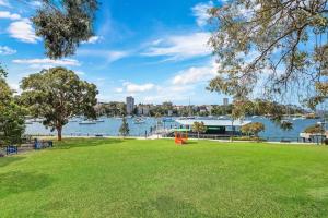 a park with a view of the water and buildings at HSNS1 - Bask in Sydney's Beauty at Harbourview Haven Apt in Sydney