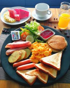 a blue plate of food with different types of breakfast foods at Triple L Hotel Patong Beach Phuket in Patong Beach