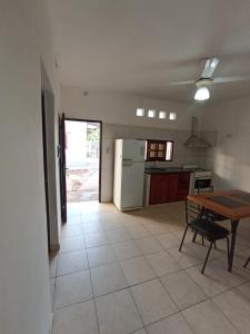 a kitchen and dining room with a table and refrigerator at Mi Luna Tucumana in Fernández +4 photos