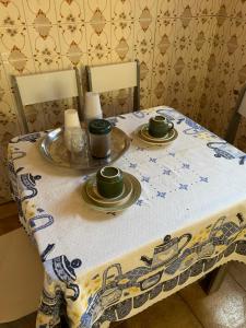 una mesa con dos tazas y platos en ella en Hostel 858, en Pelotas