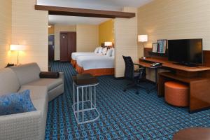 a hotel room with a bed and a desk with a computer at Fairfield Inn & Suites by Marriott Gallup in Gallup