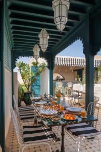 a table with plates of food on a patio at Riad Botanica in Marrakesh
