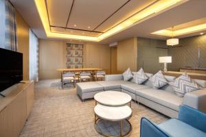 a living room with a couch and a table at Four Points by Sheraton Hefei, Baohe in Hefei