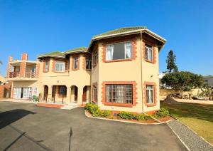 a large house with a parking lot in front of it at Tarkshay Hospitality in Densainagar