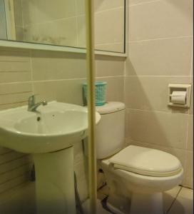 a bathroom with a toilet and a sink at Hotel Kristal, Keningau in Keningau