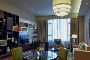 a living room with a couch and a table at Marriott Executive Apartment Tianjin Lakeview in Tianjin