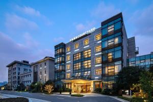 a large building with many windows in a city at Courtyard by Marriott Wuxi Lihu Lake in Wuxi