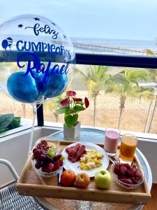 a tray of breakfast food on a table with a balloon at ADDA Pacasmayo in Pacasmayo