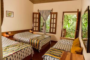 a room with two beds and a window at Hotel and Restaurant Guancascos in Gracias