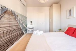 a bedroom with a large white bed and a staircase at Stay U-nique Apartments Rambla Catalunya V in Barcelona