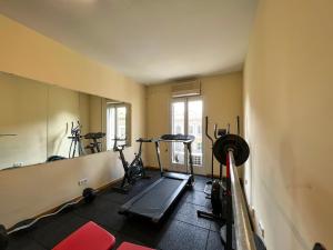 a gym with several exercise bikes and a mirror at Stay U-nique Apartments Rambla Catalunya V in Barcelona