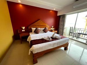 Ein Bett oder Betten in einem Zimmer der Unterkunft Aristocrat Residence & Hotel