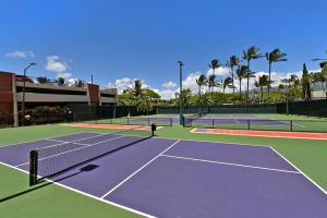 a group of tennis courts with palm trees in the background at Kaanapali Shores 527 in Kahana