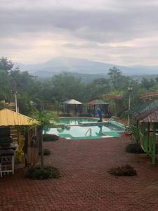 a swimming pool with a person standing in the water at Layugan garden resort bucay abra in Bangued