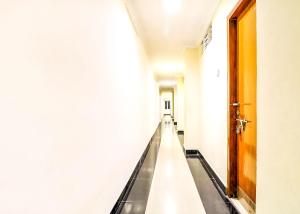 an empty corridor in a hospital with a door at SPOT ON Srinivasa Residency in Tirupati