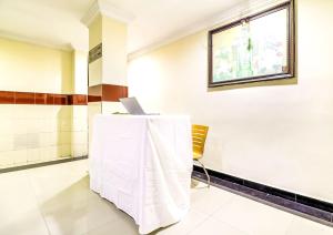 a room with a table with a laptop on it at SPOT ON Srinivasa Residency in Tirupati