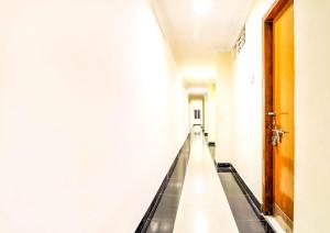 an empty corridor in a building with a door at SPOT ON Srinivasa Residency in Tirupati