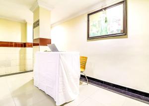 a room with a table with a laptop on it at SPOT ON Srinivasa Residency in Tirupati