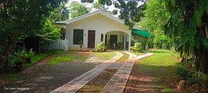 a house in the middle of a yard at The Green Weligama in Weligama