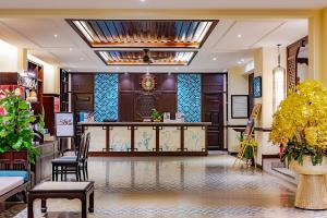 a lobby with a reception desk in a building at Wyndham Garden Hoi An Cua Dai Beach in Hoi An